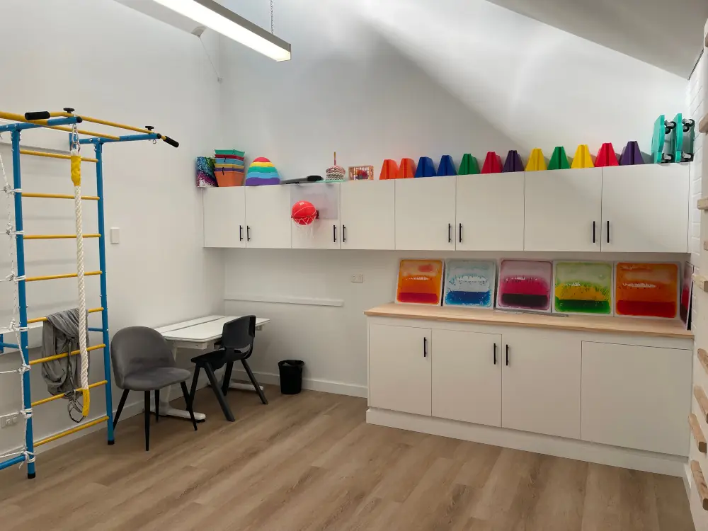 A paediatric therapy room set up with sensory and fine-motor equipment for children
