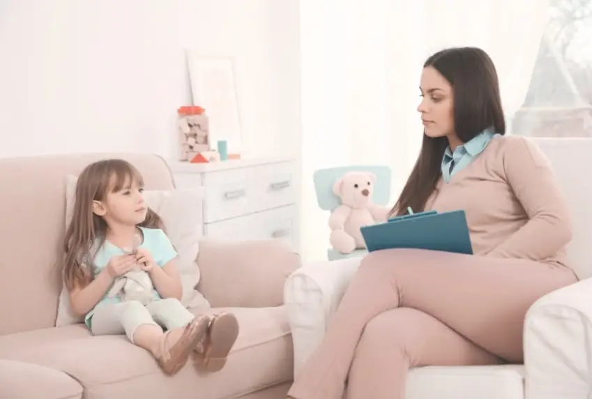 A psychologist working with a child during an assessment